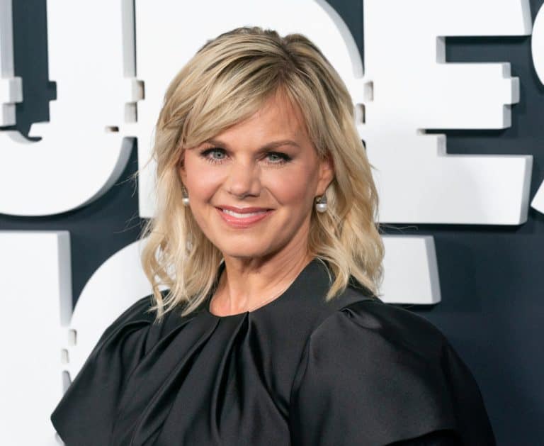 Gretchen Carlson smiling at a public event, wearing a black dress and pearl earrings.