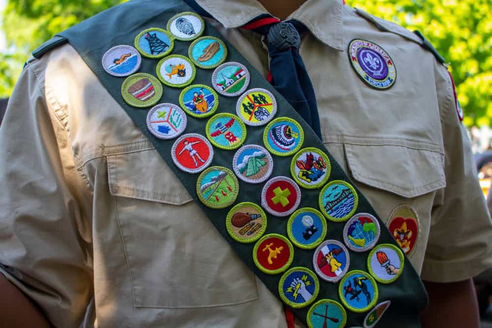 Boy Scouts of America uniform sash with merit badges – LDS Church co-sponsored thousands of BSA units now linked to abuse lawsuits.