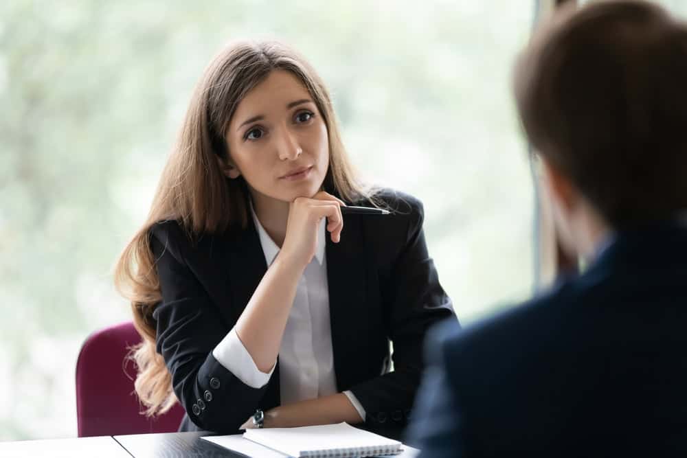 Compassionate female attorney listening to a survivor during a confidential conversation about Catholic Church sexual abuse