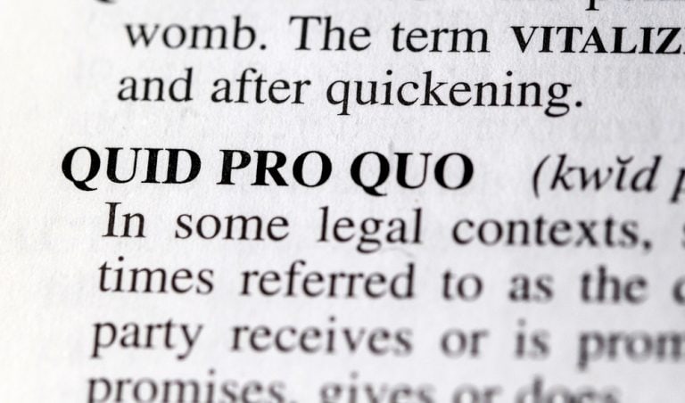 Close-up of the term 'Quid Pro Quo' defined in a legal dictionary.