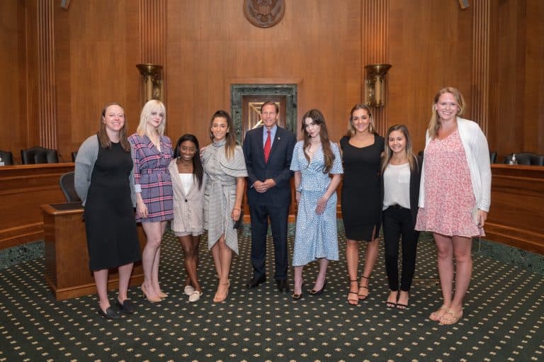 Several of the accusers of the USA Gymnastics sexual abuse scandal pictured in 2021, including Jessica Howard, Simone Biles, Aly Raisman, McKayla Maroney, and Maggie Nichols, along with U.S. Senator, Richard Blumenthal.