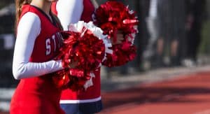 Two cheerleaders holding pom-poms.
