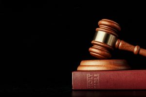 Gavel resting on a Bible, symbolizing the legal battle over clergy reporting laws in an LDS sexual abuse lawsuit.