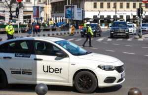 Uber vehicle parked on city street, representing ongoing lawsuits over driver sexual assaults and the company’s legal responsibility to protect passengers.