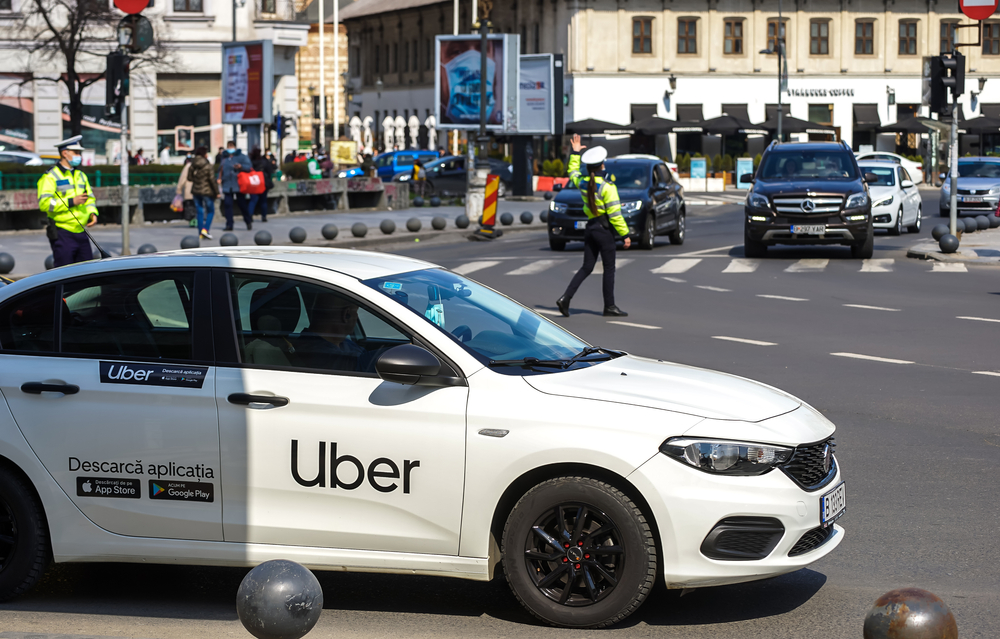Uber vehicle parked on city street, representing ongoing lawsuits over driver sexual assaults and the company’s legal responsibility to protect passengers.