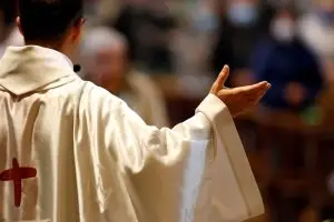 A Catholic Church service, Sunday mass - New Orleans Archdiocese sexual abuse bankruptcy and settlement.