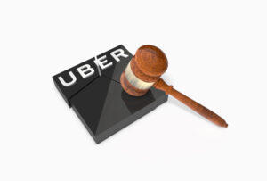 A symbolic image of the Uber driver sexual assault litigation, featuring a gavel and an Uber logo.