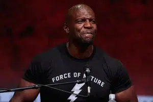 Terry Crews speaking at a panel, wearing a “Force of Nature” t-shirt.