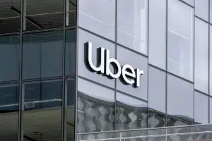 Uber headquarters building with large Uber logo on glass exterior.