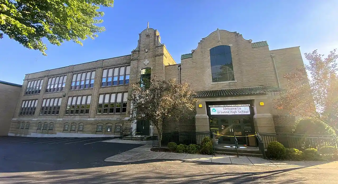 Exterior view of Ursuline High School in Youngstown, Ohio, with front entrance and school sign visible.