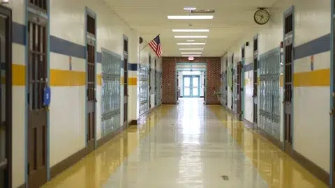 Empty hallway inside an elementary school representing allegations of institutional failures to protect students from sexual abuse
