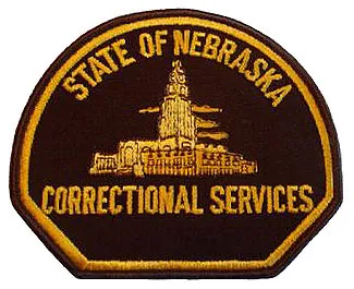 Patch of the State of Nebraska Correctional Services featuring the Nebraska State Capitol building in gold embroidery