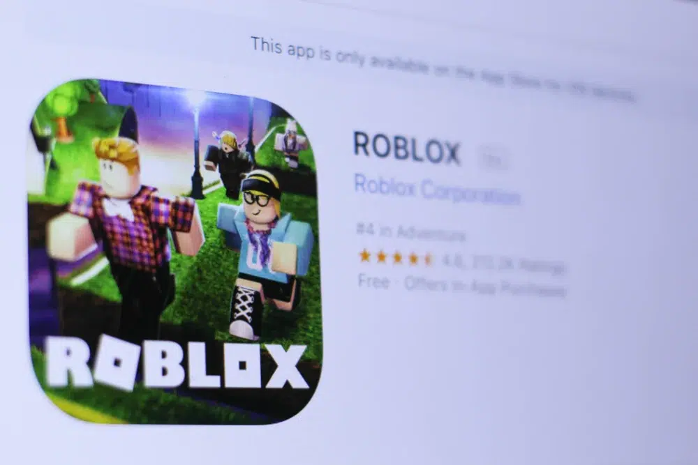 Close-up view of the Roblox app page on a digital screen, showing the Roblox logo with game characters running and the app listing details