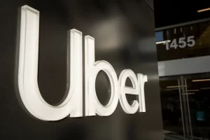 Close-up of the illuminated Uber logo on the exterior of the company’s headquarters building in San Francisco.