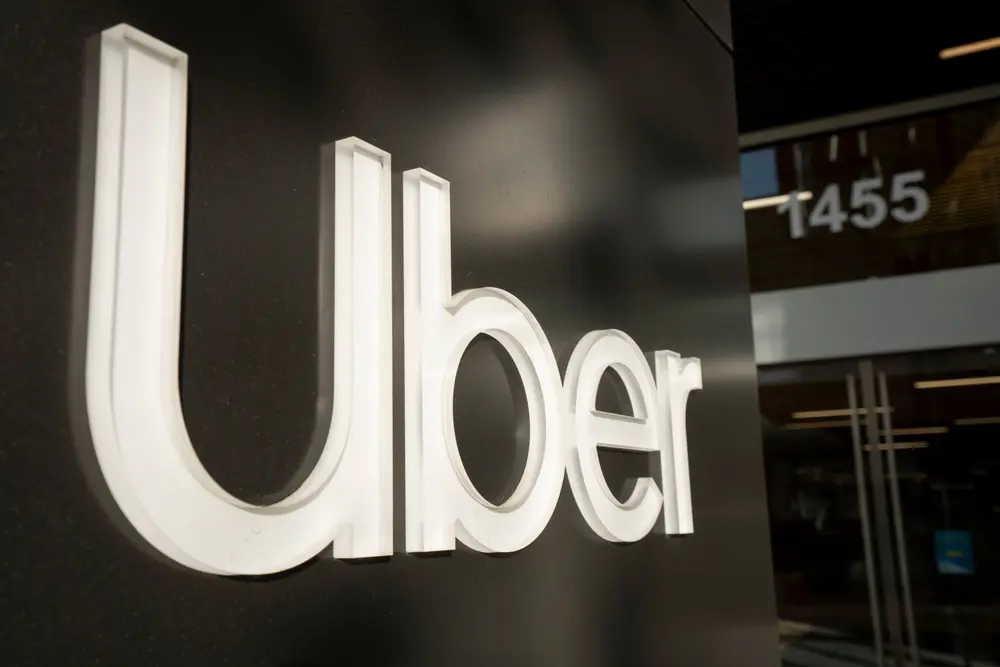 Close-up of the illuminated Uber logo on the exterior of the company’s headquarters building in San Francisco.
