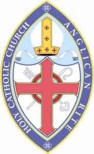 Official emblem of the Holy Catholic Church Anglican Rite, featuring a red cross, a gold mitre, and symbolic ecclesiastical elements within a blue oval border.