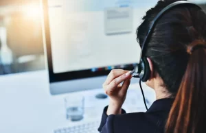 la-hotline Call center operator wearing a headset while working at a computer, representing Los Angeles County’s new 24/7 child sex abuse reporting hotline
