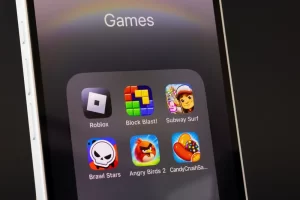 Smartphone screen displaying the Roblox app icon alongside other mobile games.
