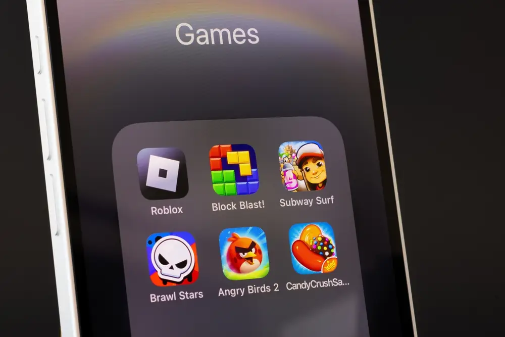 Smartphone screen displaying the Roblox app icon alongside other mobile games.