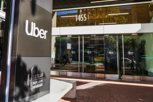 Exterior view of Uber’s headquarters building with the Uber logo displayed on the entrance signage.