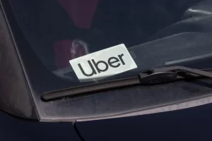 Uber logo displayed on the windshield of a rideshare vehicle, representing Uber amid ongoing sexual assault litigation and rider safety concerns.