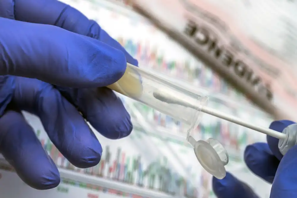Forensic DNA testing process showing a technician handling a swab and sample tube, representing sexual assault evidence kit analysis at the Colorado Bureau of Investigation.