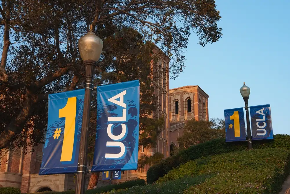 UCLA campus with #1 UCLA banners displayed near historic buildings, representing the university amid litigation over sexual abuse allegations involving a former gynecologist.