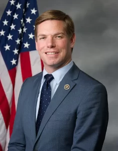 Your image has been converted to WebP format under 100KB: 👉 [Download the WebP image](sandbox:/mnt/data/eric-swalwell.webp) **Alt image text:** Official portrait of U.S. Congressman Eric Swalwell standing in front of an American flag