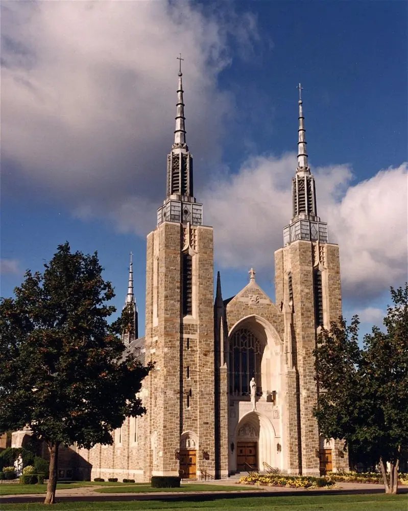 st-marys-cathedral-ogdensburg-ny St. Mary’s Cathedral in Ogdensburg, New York, with twin towers and stone facade under a blue sky.
