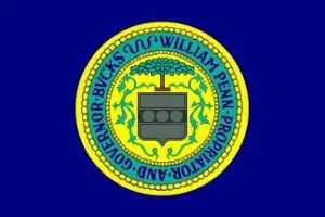 bucks-county-flag Flag of Bucks County, Pennsylvania, featuring the county seal on a dark blue background.