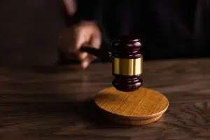 uber_shareholder_lawsuit_gavel_1600_q85 Judge’s gavel on a wooden desk, symbolizing litigation related to Uber rider safety and sexual assault lawsuits.