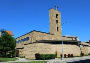 co-cathedral-st-john-rochester-minnesota Co-Cathedral of St. John the Evangelist in Rochester, Minnesota, with its stone bell tower and cross beneath a clear blue sky.