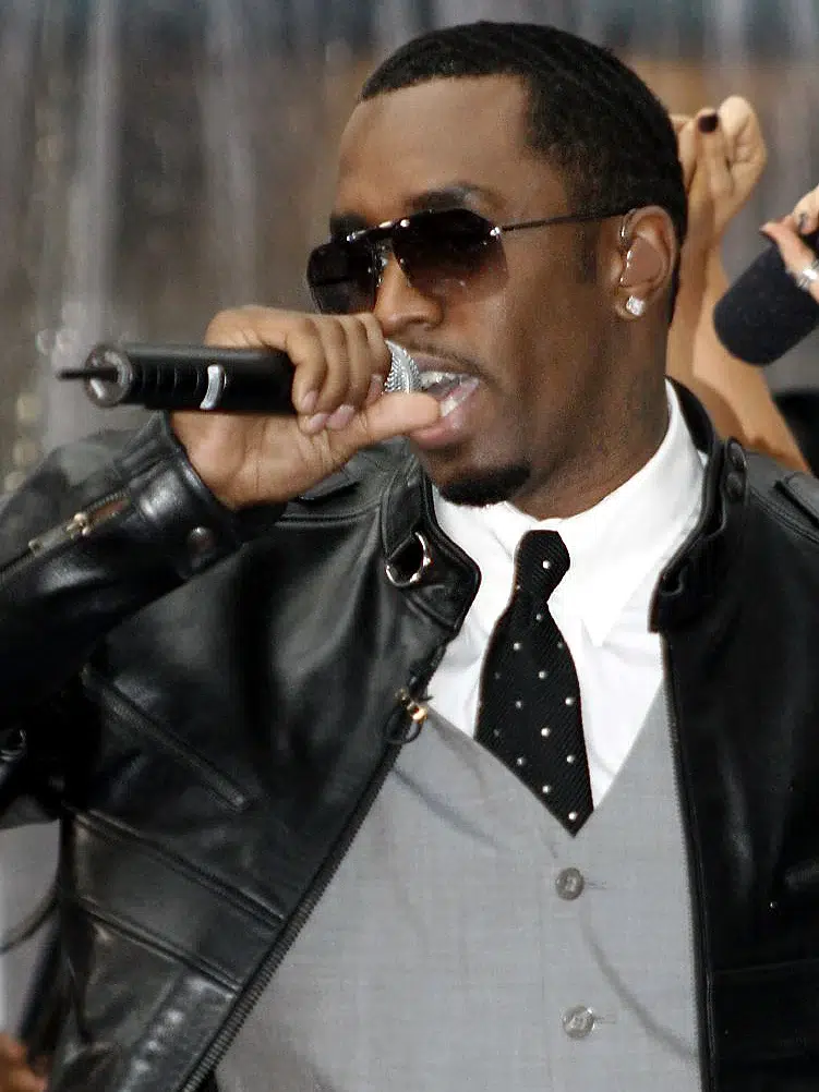 sean-combs-gmva-lawsuit Sean “Diddy” Combs performing with a microphone, shown in coverage of a lawsuit involving New York City’s Gender-Motivated Violence Protection Law.